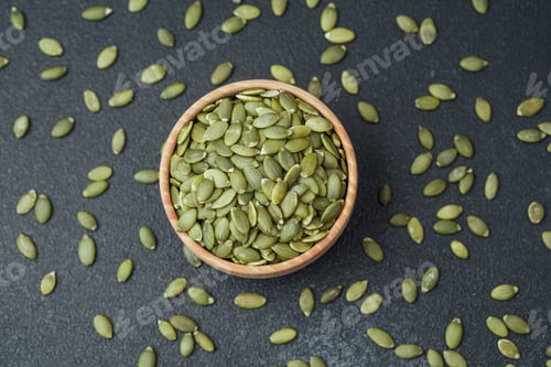 Preview: Pumpkin seeds in wooden bowl