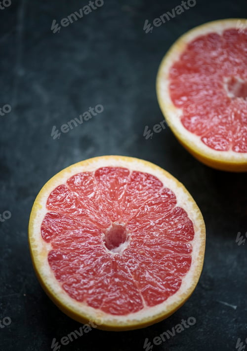 Preview: Closeup of grapefruit slices on black table
