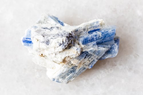 Preview: sample of unworked kyanite rock on white marble