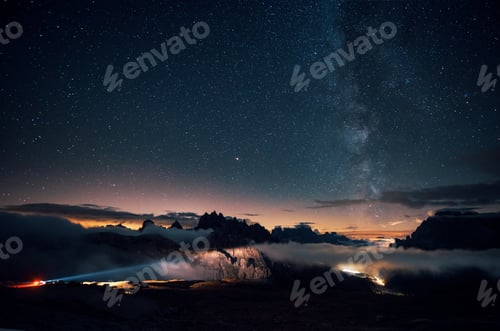 Preview: Beautiful space filled with stars in the sky. The mountains are surrounded by dense fog