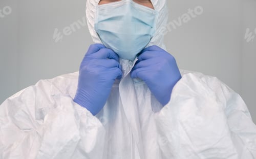 Preview: A nurse prepares by putting on protective suit during coronavirus pandemic.