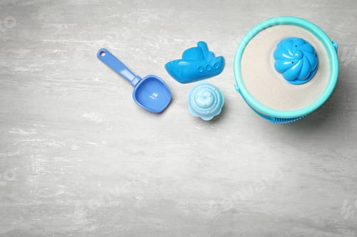 Preview: Flat lay composition with beach toys on light background. Space for text