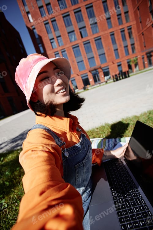 Preview: POV of Asian young woman taking selfie photo outdoors