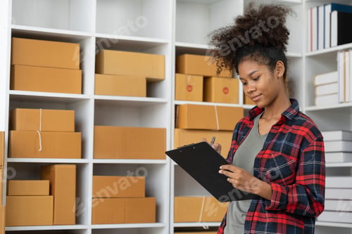 Preview: SME business owner African American female entrepreneur Checking orders and checking the number of p