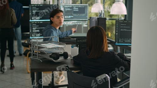 Preview: Asian software developer with impairment writing code with html script in data room