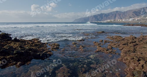 Preview: Splashing waves. Black rocky volcanic beach with black lava stones. Puerto de la Santiago, Tenerife