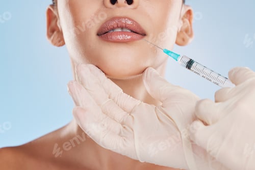 Preview: Beautiful young mixed race woman getting plastic surgery botox injection into her lips. Attractive