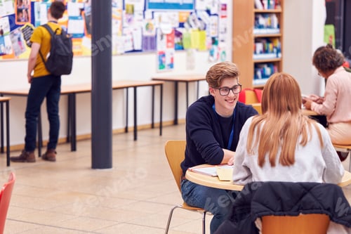 Preview: Communal Area Of Busy College Campus With Students Working At Tables