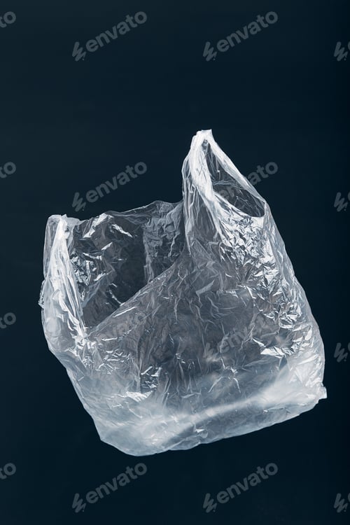 Preview: White empty plastic bag floating over black background. Plastic pollution. Plastic waste