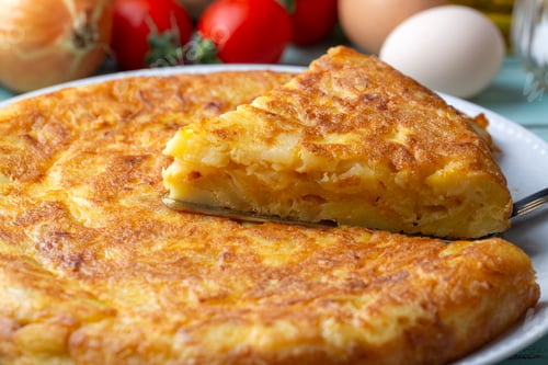 Preview: Spanish omelette with potatoes, typical spanish cuisine on gray concrete floor. Tortilla Espanola.