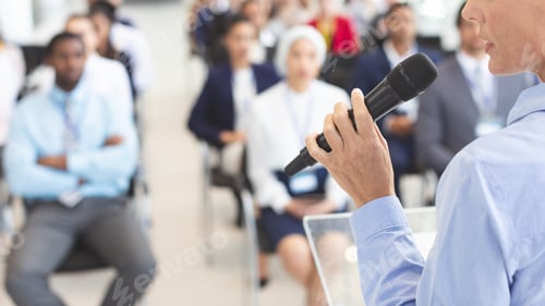 Preview: Female speaker speaks to diverse business people in business seminar in conference room