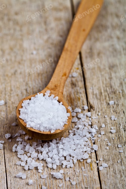 Preview: Wooden spoon with sea salt closeup on wooden rustic table.