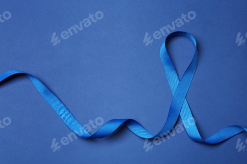Preview: Blue ribbon on color background, top view. Colon cancer awareness concept