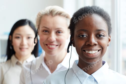 Preview: Smiling African-American Operator Standing in Row
