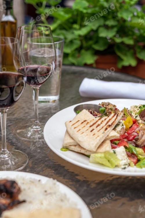Preview: Closeup of delicious vegetarian dinner entrees on table at Mediterranean tapas restaurant