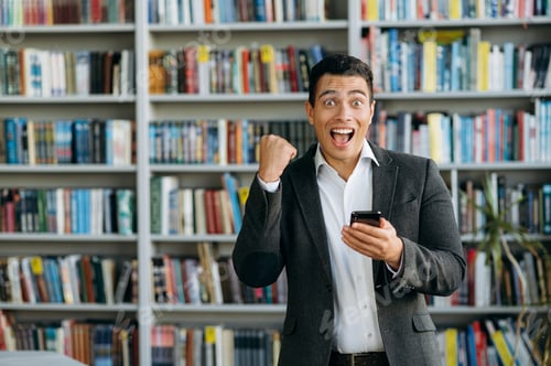 Preview: Excited Man Celebrating Success With Mobile Phone