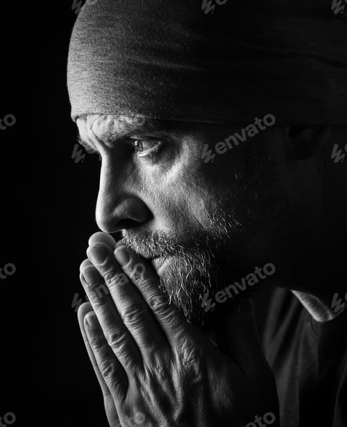 Preview: Grayscale shot of a Caucasian (White) male praying