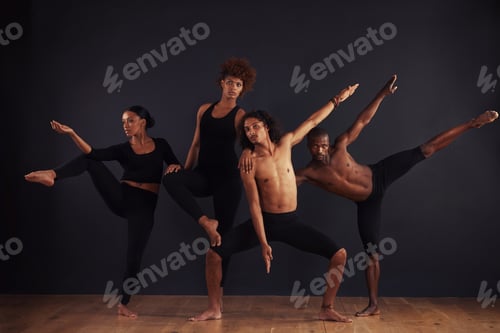 Preview: Powerful individuals. A group of dancers performing a dramatic pose in front of a dark background.