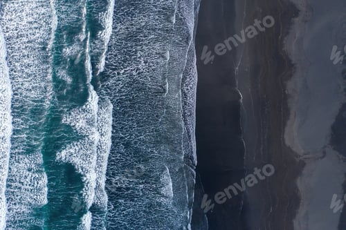 Preview: Aerial drone view of ocean waves washing black basaltic sand beach, Iceland