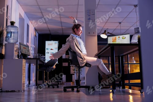 Preview: Entrepreneur doing relaxation exercises in startup office