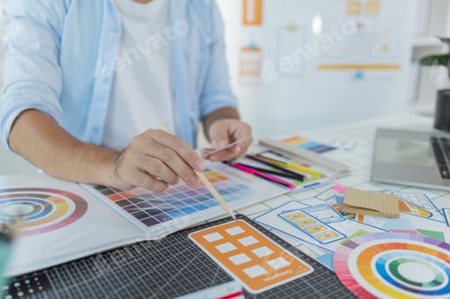 Preview: A designer is working on a creative UX UI project at a desk