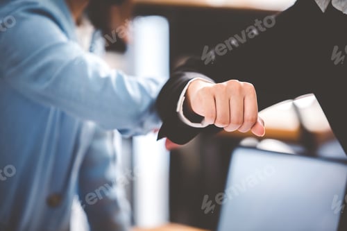 Preview: business people clashing hands It represents a new kind of teamwork.