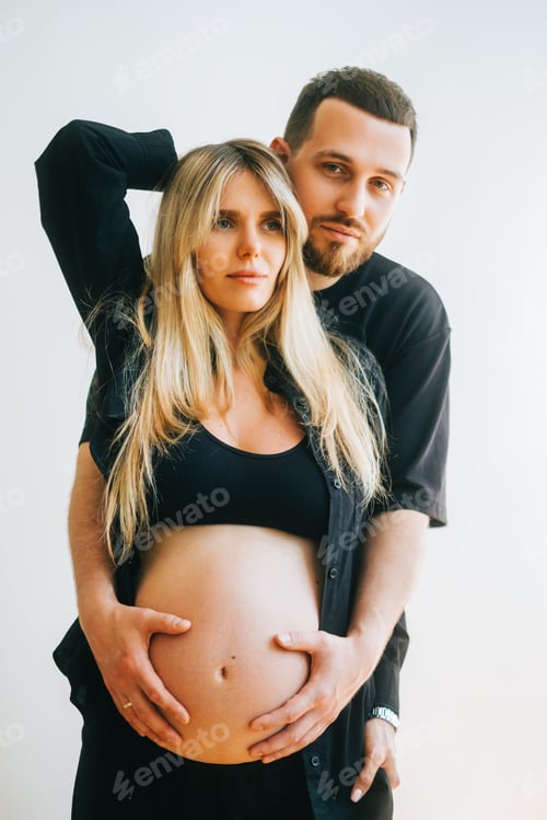 Preview: Expecting Couple Embrace at Home in Black Clothing