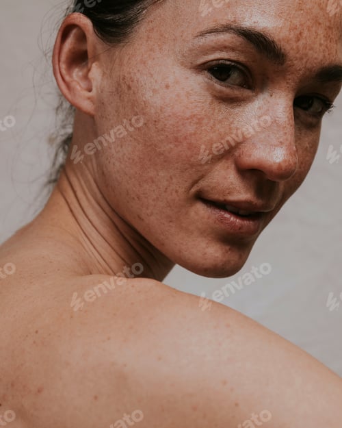 Preview: American woman looking over bare shoulder photo