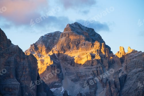 Preview: High rocks during sunset. Dolomite Alps, Italy. Mountains and cloudy skies. View of mountains and cl