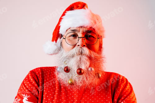 Preview: Senior old man with gray beard with Santa Claus portrait in studio