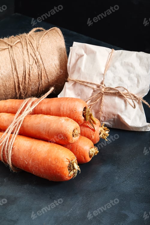 Preview: Fresh carrots, dark background. Copy space, close-up, photo for a grocery store