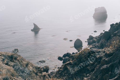 Preview: Wild sea during winter. Dramatic scenery with dark clouds and heavy fog above the water