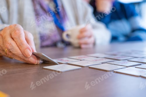 Preview: Senior woman's hand playing a board game