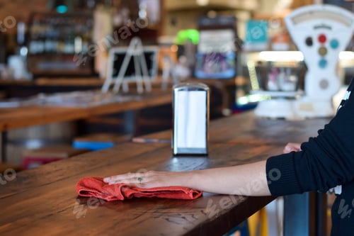 Preview: Server wiping restaurant table