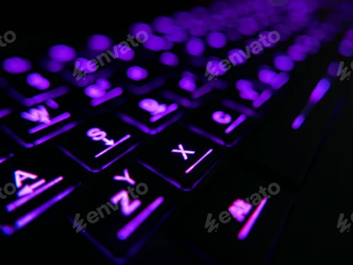 Preview: Close-up image of computer keyboard with purple illumination.