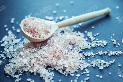 Preview: bowl of pink himalayan salt on dark table, top view, copy space