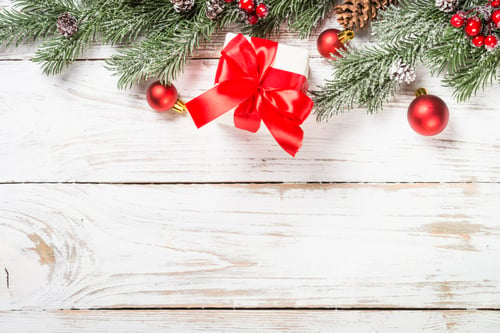Preview: Christmas Gift on a Snowy White Wooden Background