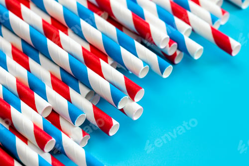 Preview: Drinking straws for party on blue background, close up.