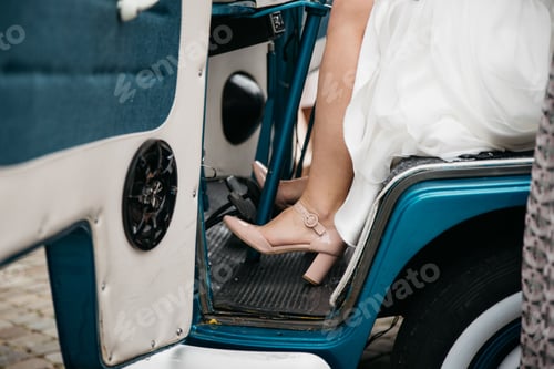 Preview: Closeup of female feet wearing high hills in the car trying to press on pedals