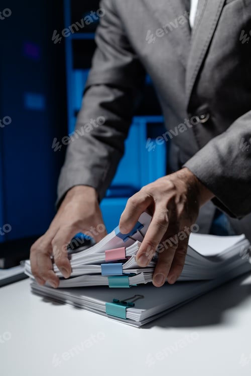 Preview: An employee held a large pile of documents in his hand, Large piles of work documents on desks are b