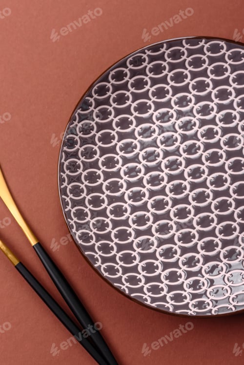 Preview: Empty ceramic plate on a monochrome brown background
