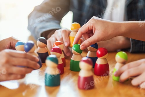 Preview: People choosing and picking up wooden figure from a group on the table
