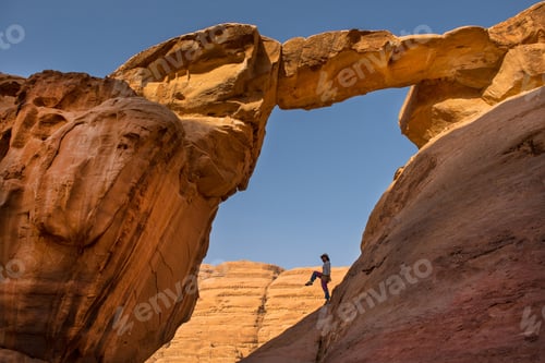 Preview: Tourist posing at Um Fruth rock bridge. Wadi Rum desert, Jordan