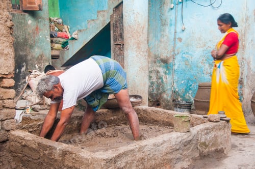 Preview: Potter preparing clay for making pots, India.