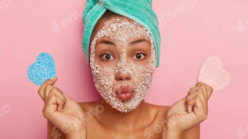Preview: Image of attractive young lady makes grimace, keeps lips folded, looks directly at camera, has dark