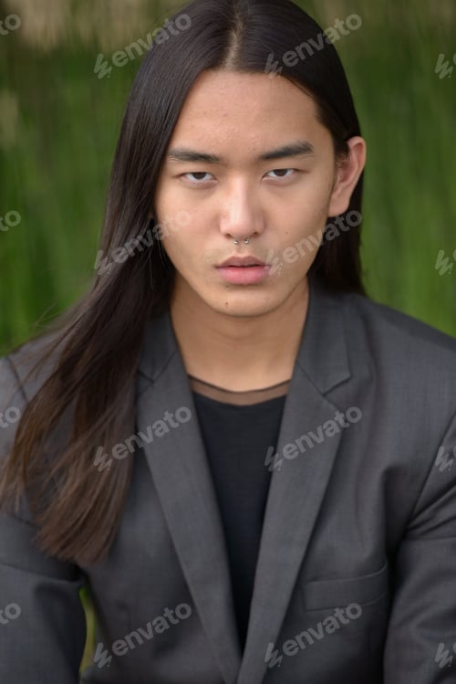 Preview: Portrait of young Asian man with long hair