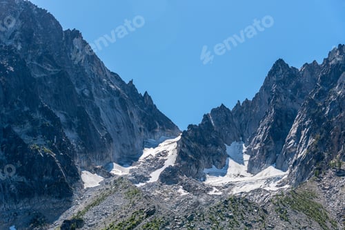 Preview: Jagged rock mountain peaks with melting glacier sheets.