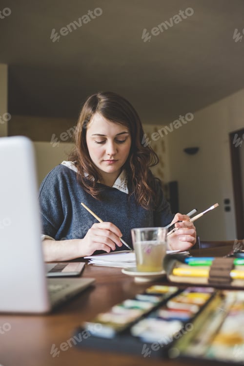Preview: Young woman artist working at home