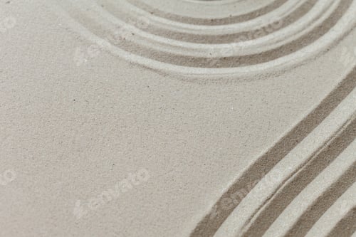 Preview: Patterns created in sand at a beach on a sunny day with gentle waves