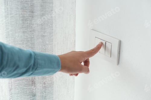 Preview: Woman pressing a light switch